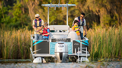 Two men and two children fishing while wearing lifejackets